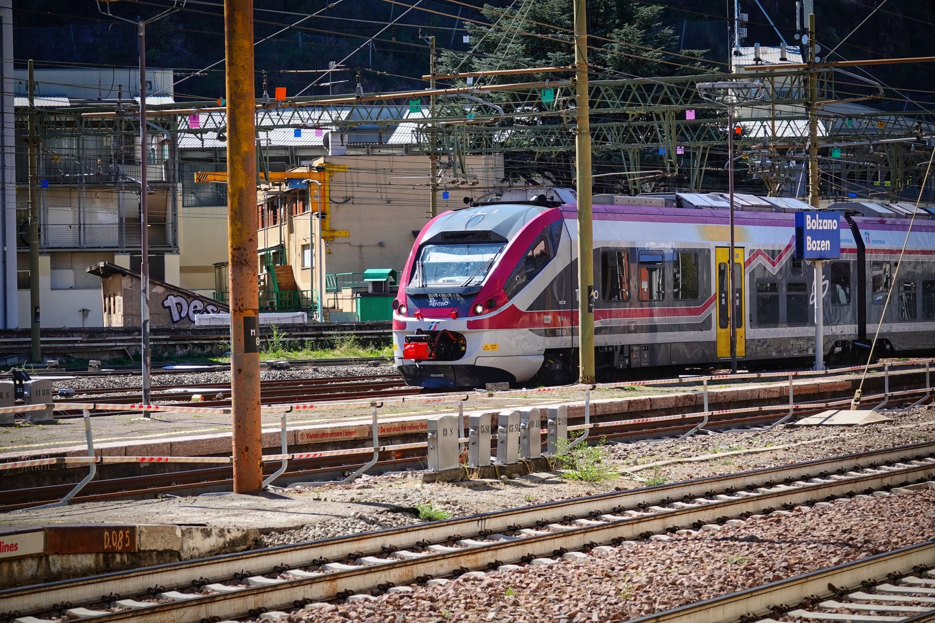 Train beside the Bolzano Bozen platform sign