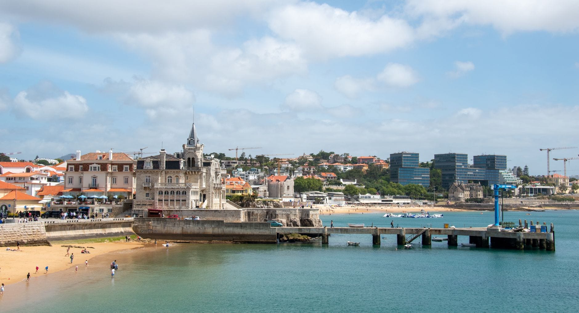 Cascais bay with sandy beach, seafront buildings and pier